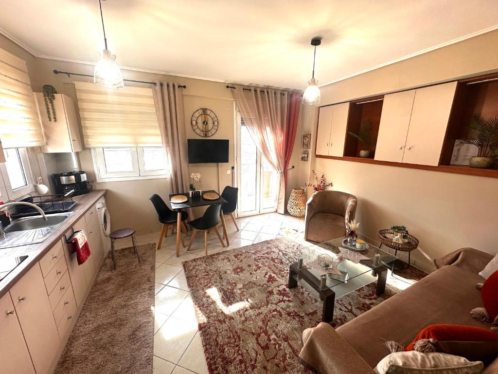 a kitchen and living room with a couch and a table at Argiro's apartment in Mytilene