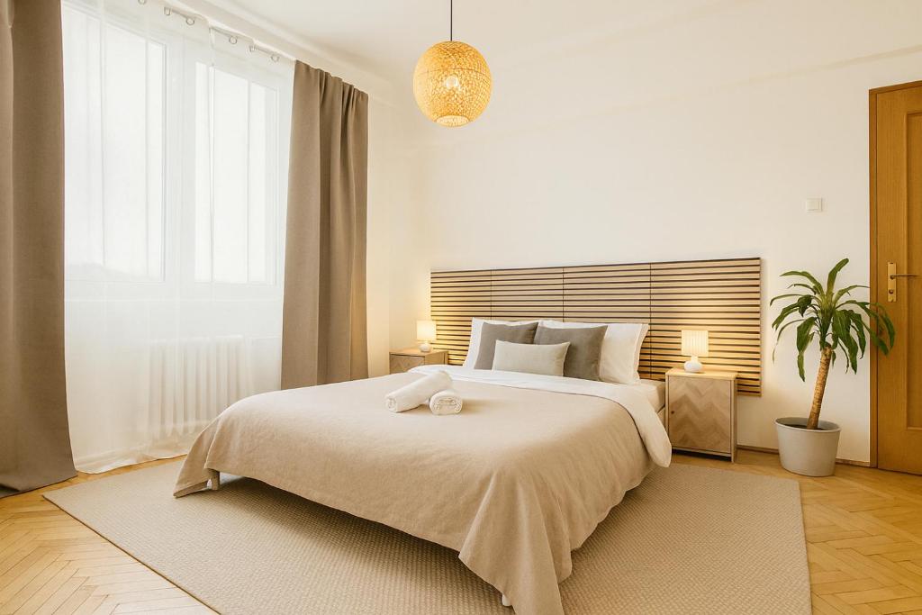 a bedroom with a bed with a stuffed animal on it at Budovatelska Apartment in Bratislava