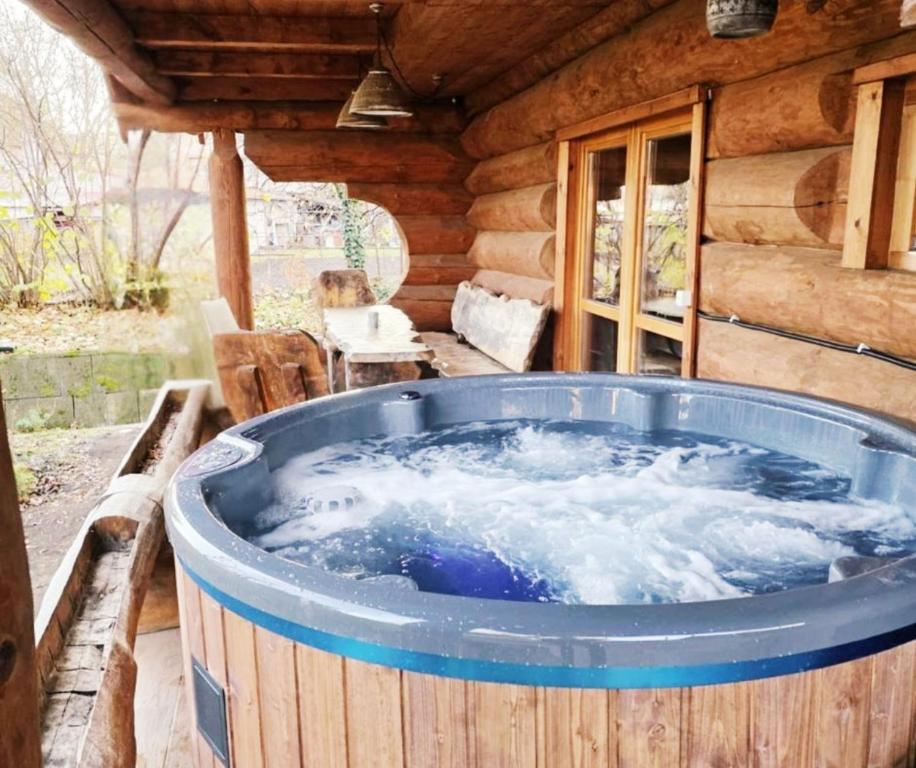 a large jacuzzi tub sitting outside of a cabin at Levendula Resort és Rendezvényközpont in Bogács