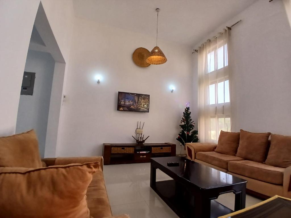 a living room with a couch and a table at Ary Homestay Nyali- Town Home Behind Citymall in Mombasa