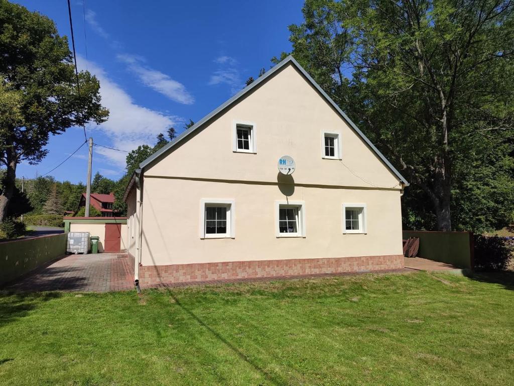 a large white house with a large yard at Chata Luisa in Nová Komora
