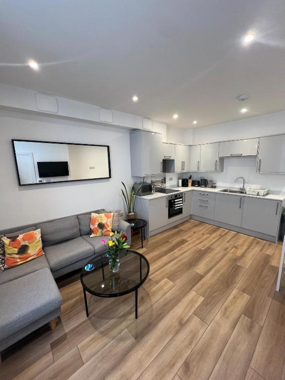 a living room with a couch and a table at 1 Bed Apartment in Town Centre in Newquay