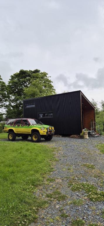 a yellow car parked in front of a building at Hilltop Cabin in Cultra
