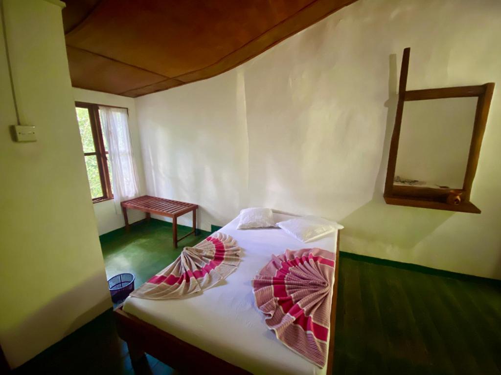 Ένα ή περισσότερα κρεβάτια σε δωμάτιο στο Handunkanda Nature Escape