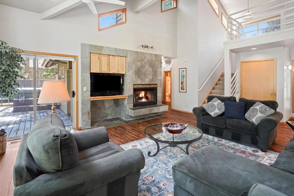 a living room with two couches and a fireplace at 1 Colonial in Sunriver