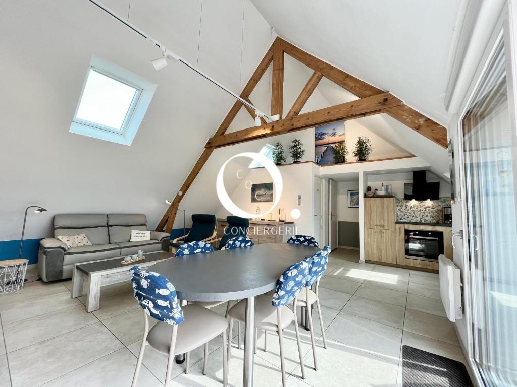 ein Esszimmer und ein Wohnzimmer mit Tisch und Stühlen in der Unterkunft COC - Les Sables Blancs in Wissant