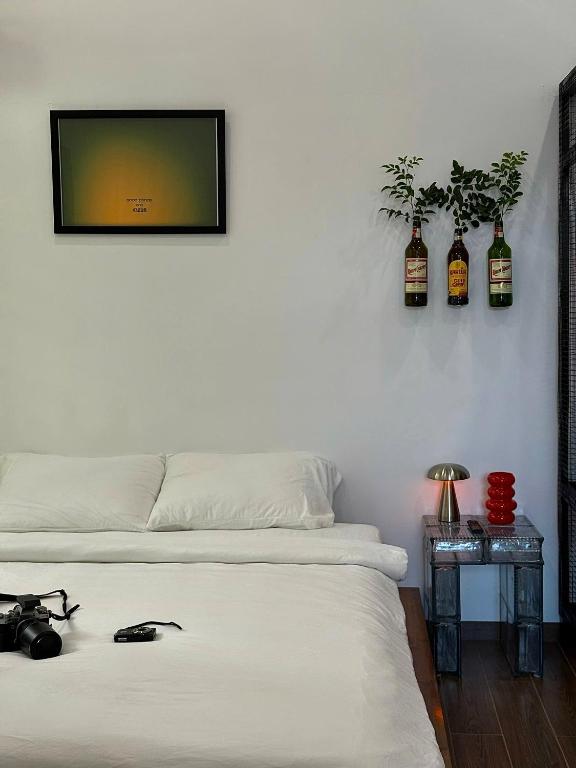 a bedroom with two beds and a tv on the wall at KINARI space Gleam in Hue