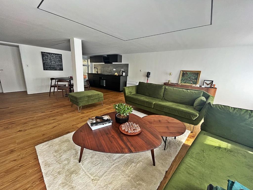 a living room with a couch and a table at Cabinet de rêveries #2 in Cassel