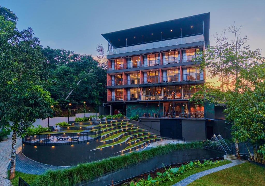 a building with a staircase in front of it at The Saray Munnar Luxury Resort with Pool by VOYE HOMES in Munnar