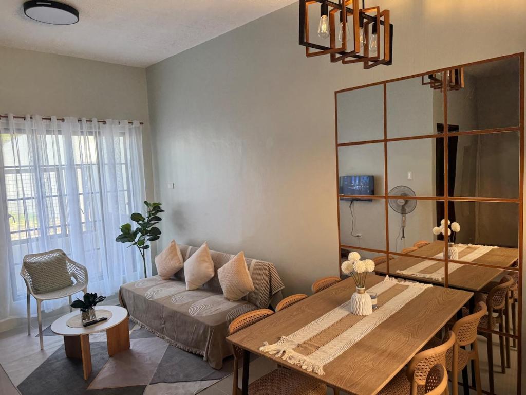 a living room with a couch and a table at Surfers Shell Dahican in Dahikan