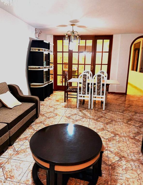 un salon avec un canapé, une table et des chaises dans l'établissement Departamento con Estacionamiento Tacna, à Tacna