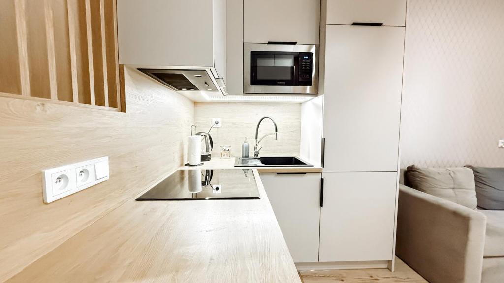 Η κουζίνα ή μικρή κουζίνα στο Piotrkowska 44 Apart By DreamAp