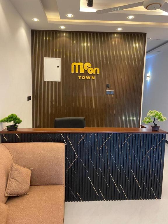a reception desk with a mtn town sign on a wall at Moon Town in Aluthgama