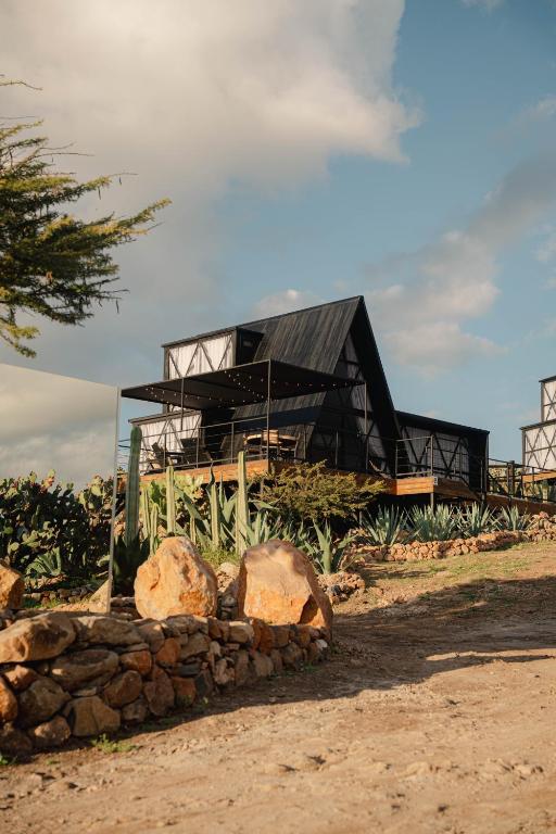 a house with a black roof on top of a pile of rocks at Hotel Coyote in San Miguel de Allende