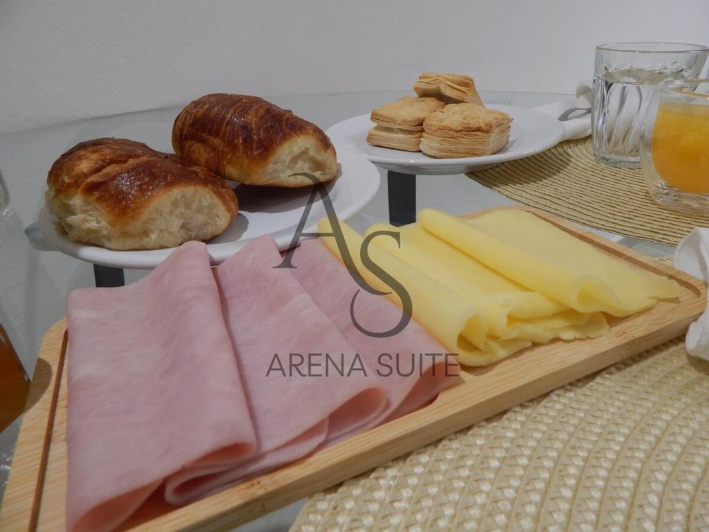 a table with a tray of cheese and other foods at Arena Suite LR in La Rioja