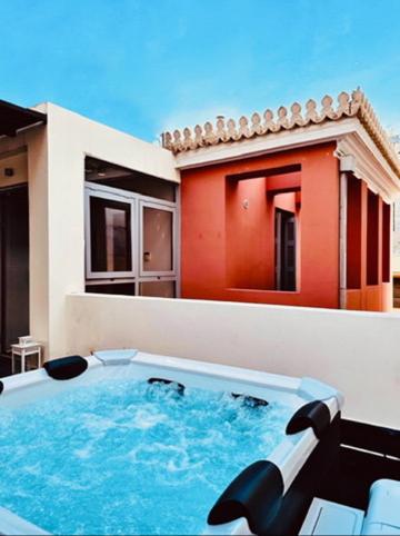 a swimming pool on the side of a house at Pink Mango Hostel in Athens
