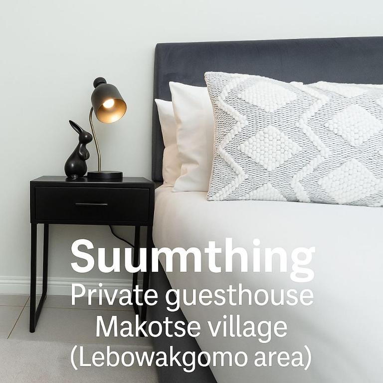 a bedroom with a bed and a table with a lamp at SUumthing Private GuestHouse in Lebowakgomo