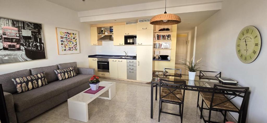 a living room with a couch and a table at Departamento Corriquia in Playa Blanca