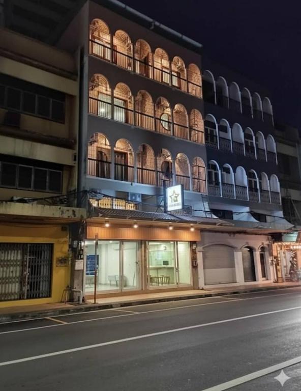 a building on the side of a street at night at Starhouse in Hat Yai