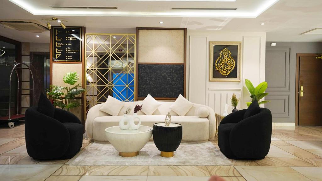 - un salon avec un canapé blanc et des fauteuils noirs dans l'établissement Best Western Plus Grand Multan, à Multan