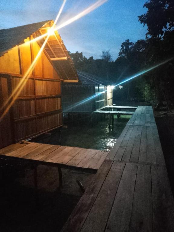 a house with a dock with a light on it at Fam Wall Homestay in Keruo