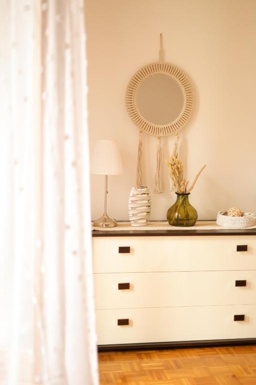 a dresser in a room with a mirror at La casa di Bianca - Casa Vacanze in Villa Opicina