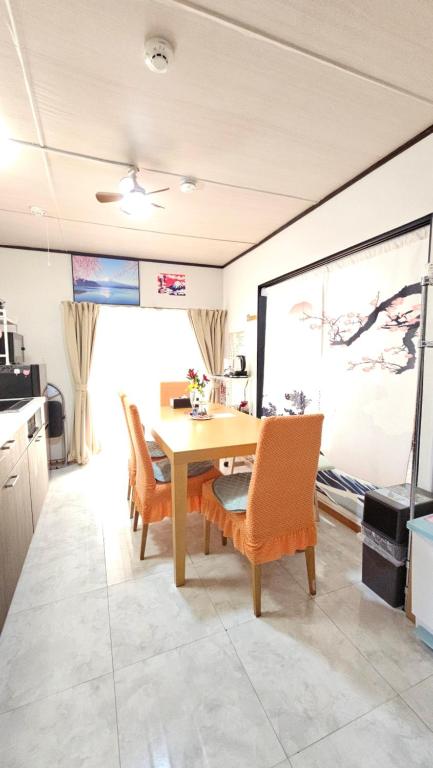 a kitchen with a table and chairs in a room at YAHouse in Chiba