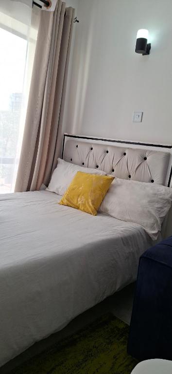 Ένα ή περισσότερα κρεβάτια σε δωμάτιο στο Tsavo sunset