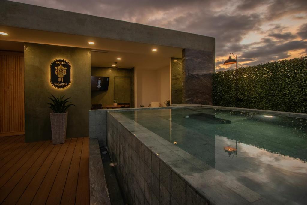 a swimming pool in a house with a house at Casa Ziña in Oaxaca City
