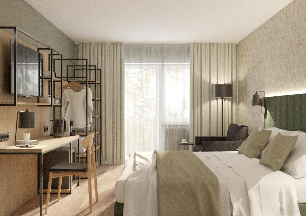 Un dormitorio con una cama y un escritorio y una cocina. en Hotel Blutenburg, en Múnich