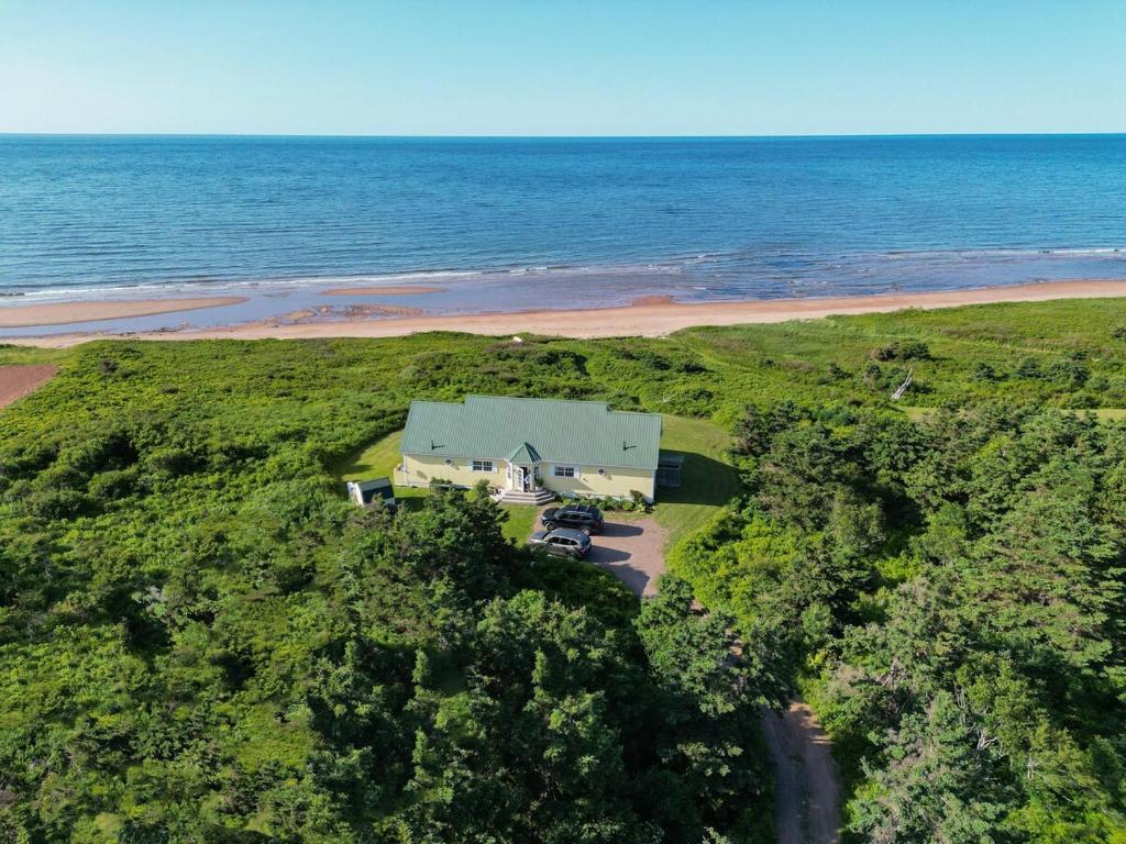 an aerial view of a house on the beach at Summer By The Sea Beach House in Saint Peters