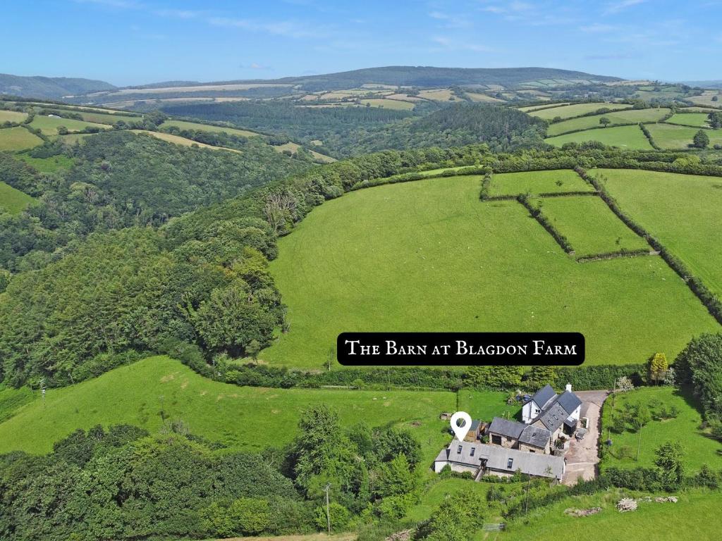 a house in a field with a sign that reads the bank at bacon farm at The Barn at Blagdon Farm, Exmoor - sleeps 10 in Wheddon Cross