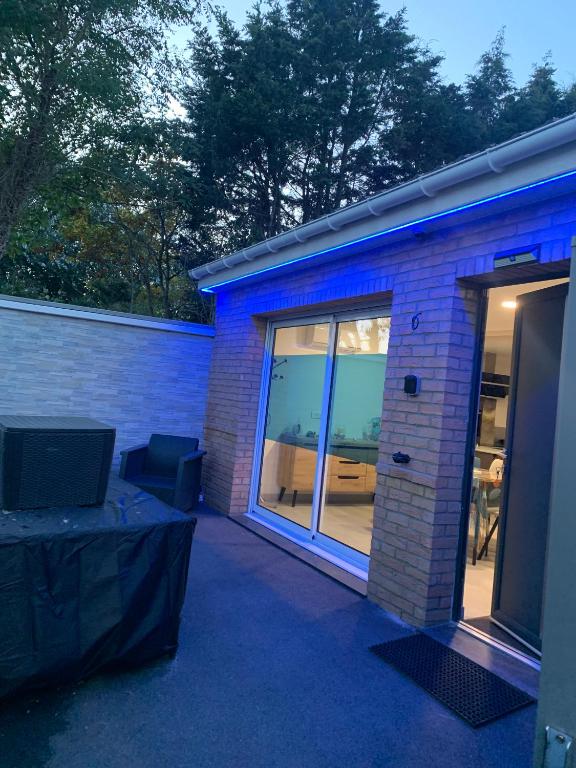 a house with a large window and a patio at La Vague in Gravelines