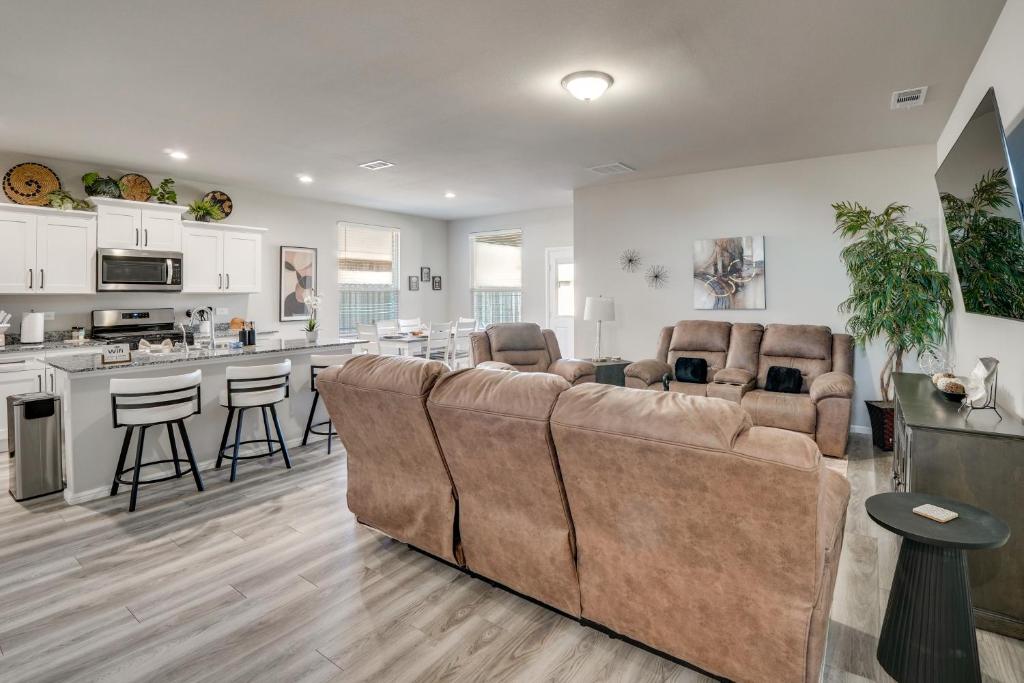 a living room with a couch and a kitchen at Work, Explore and Unwind Lovely Permian Basin Home in Odessa