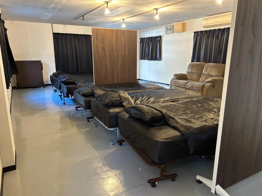 a room with a row of beds and chairs at K5 Building - Vacation STAY 20273 in Nabegayato