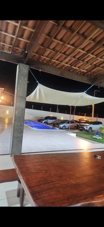 a parking lot with cars parked under a white tent at Chácara de vidro in Canindé de São Francisco
