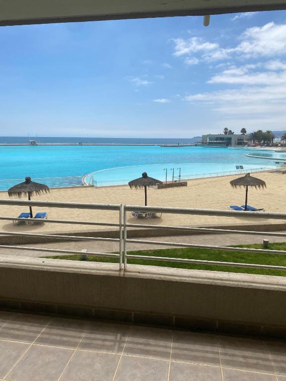 a view of a beach with umbrellas and the ocean at San Alfonso del Mar, Vela Mayor in Algarrobo