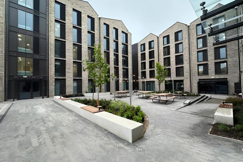 a courtyard in a building with benches and buildings at For Students Only The Brook in Bath in Bath