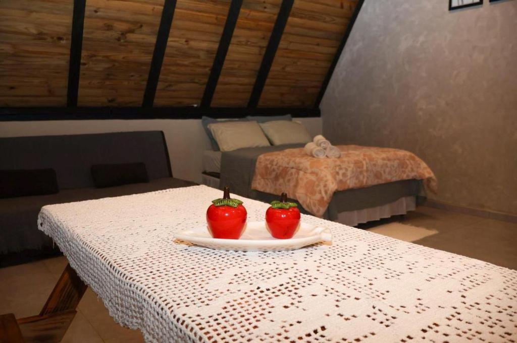 two tomatoes sitting on a table in a room at Cantinho do Vale# in Pomerode