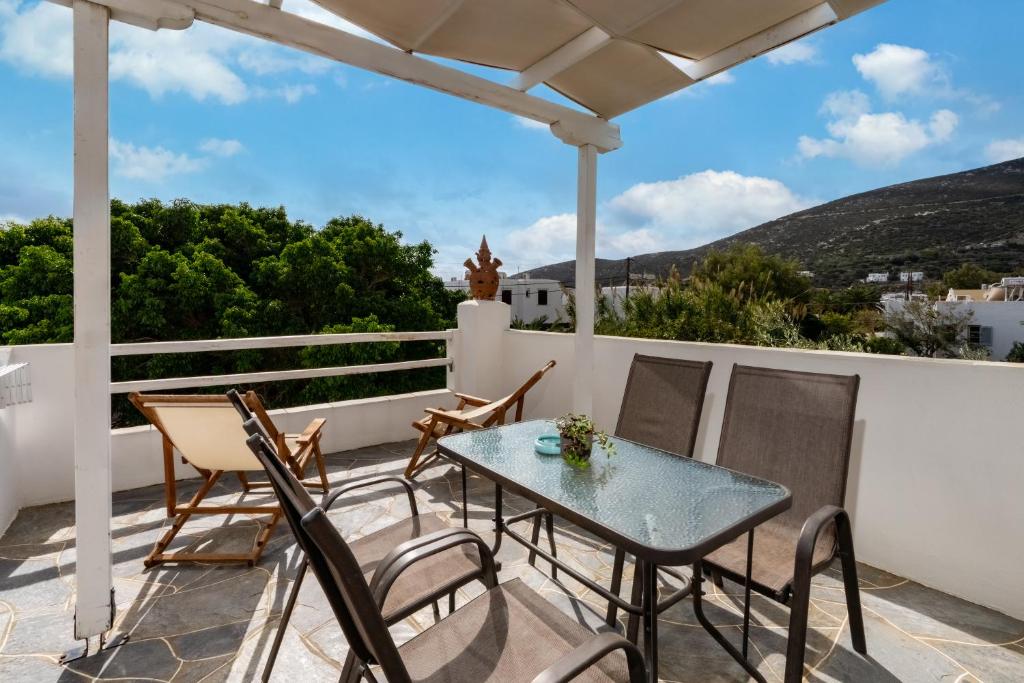 a patio with a table and chairs on a balcony at Cyclades Beach Apartments in Platis Gialos