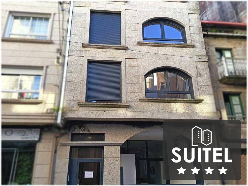 un edificio con un cartel delante en Cíes Premium Suitel Ponte 9 - Love your Stay, en Marín