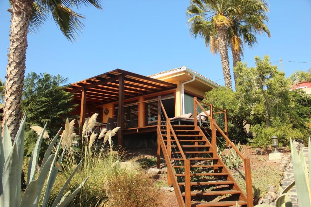 a house with stairs leading up to it with palm trees at Casa Sevilla in Guía de Isora