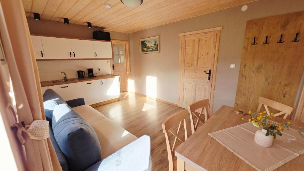 a living room with a table and a couch at Gospodarstwo agroturystyczne U Gazdy in Wisła