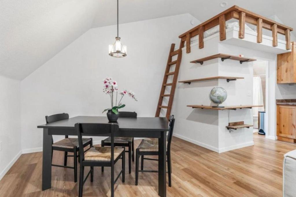 a dining room with a black table and chairs at Montgomery Apartment in Redding