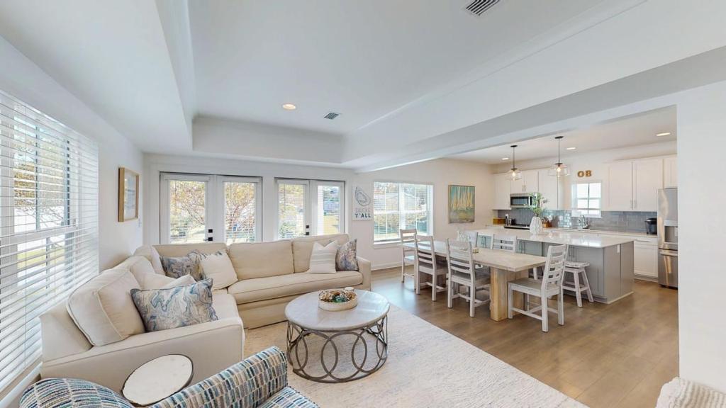 a living room with a couch and a table at New Home 3br/25br w/ kayak access sleeps 9 in Orange Beach