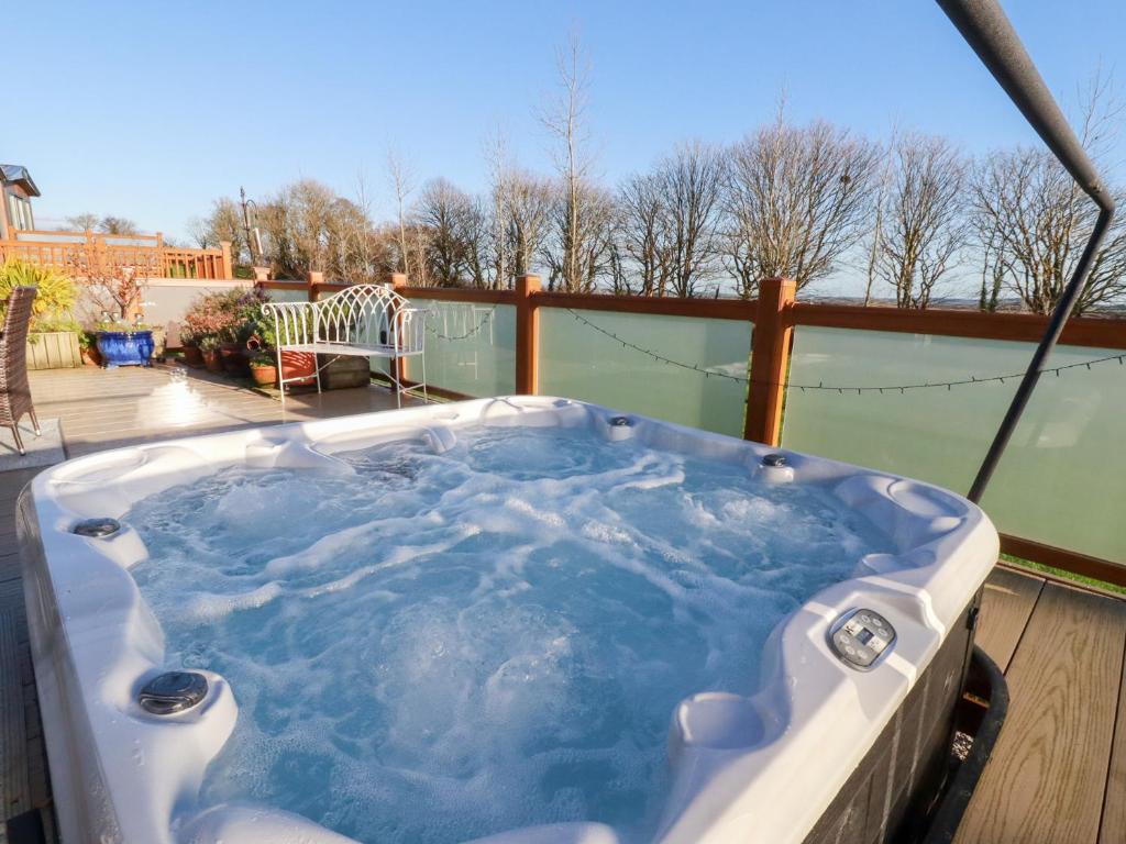 a jacuzzi tub sitting on a deck at Fairways 4 in Liskeard