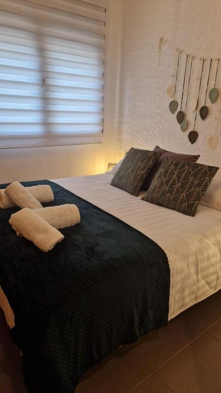 a large bed with two pillows on top of it at Lo Pateret in Corbera
