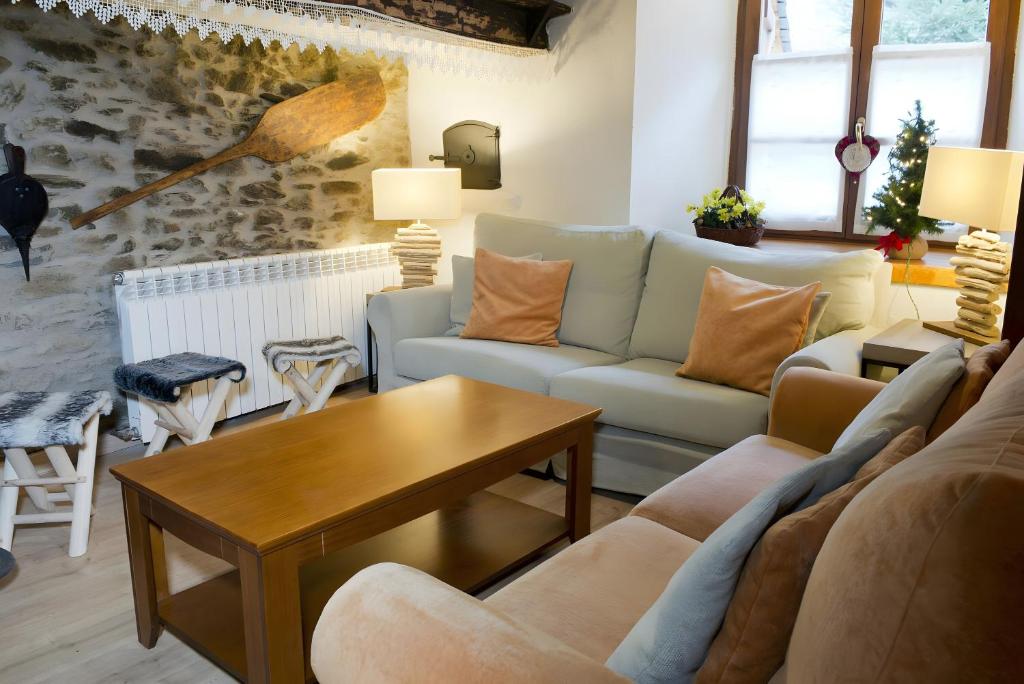 a living room with a couch and a table at Ço de Carles in Garós