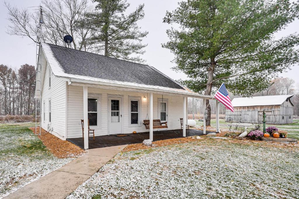 a white house with a flag in front of it at Pet-Friendly Home with River Access in Crothersville in Scottsburg