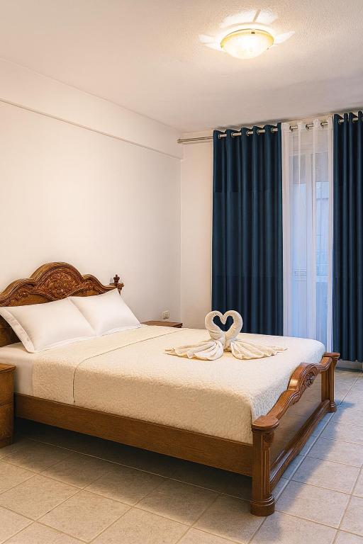 a bedroom with a bed with a ribbon on it at Tirana Panorama in Tirana